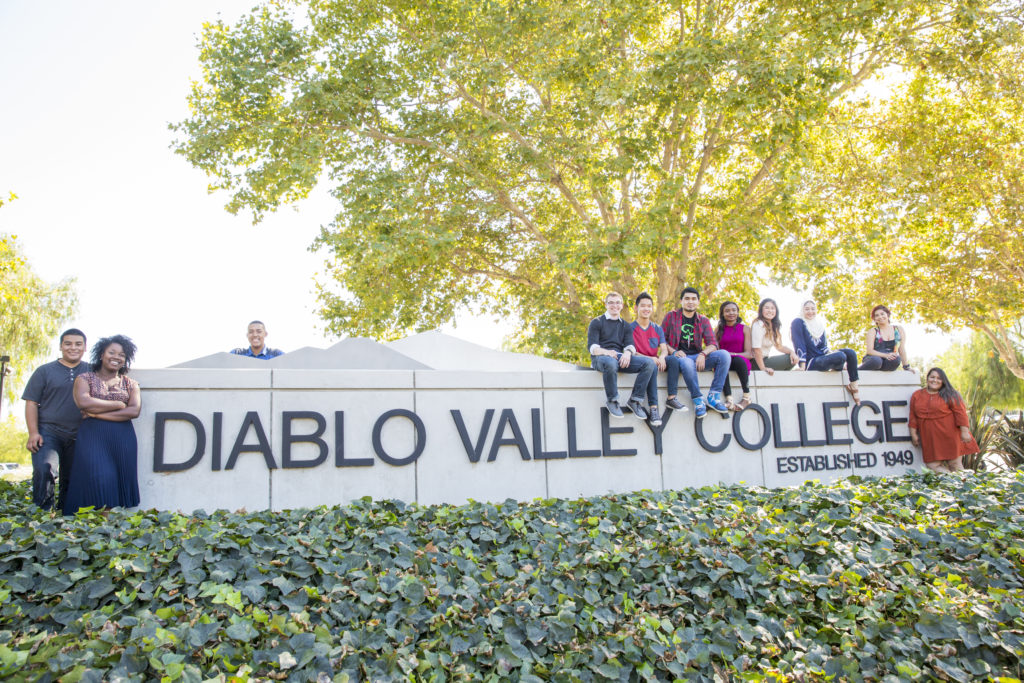 Students Pose with DVC Wall